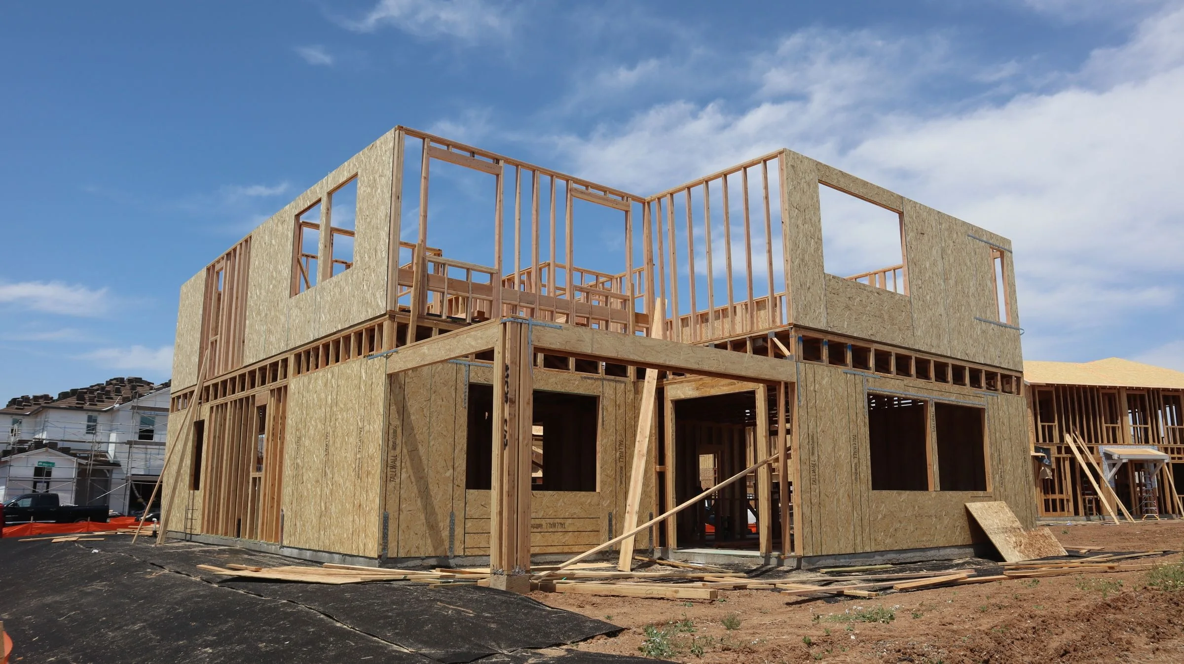 New house with stud walls framed on the floor platform and openings for windows and doors