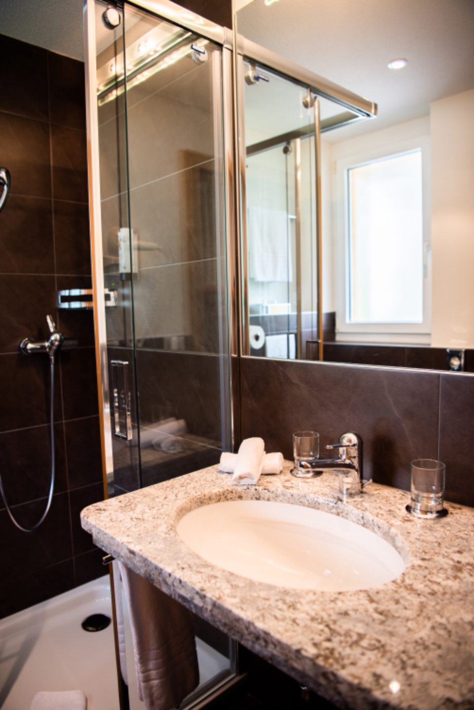 Glass shower enclosure and vanity