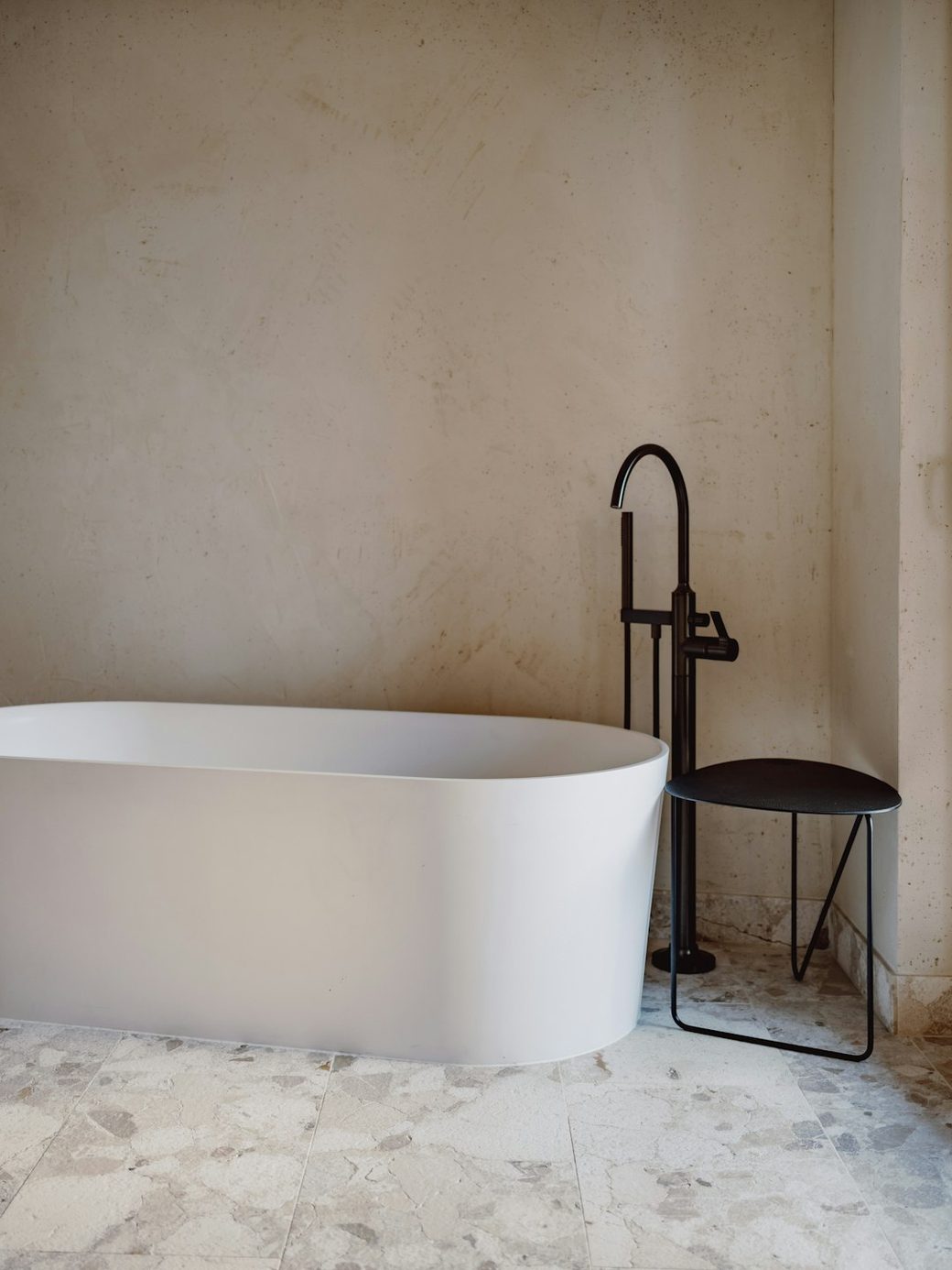 Freestanding tub closeup with black fixtures