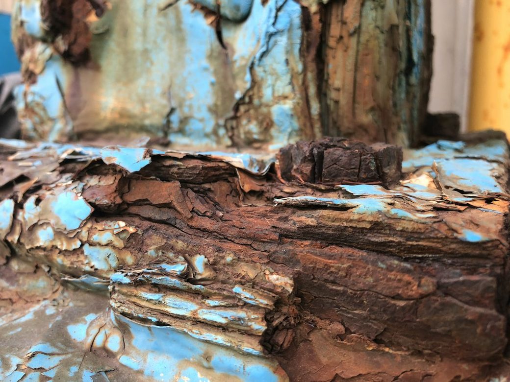 Rotted wood beam with flaking paint