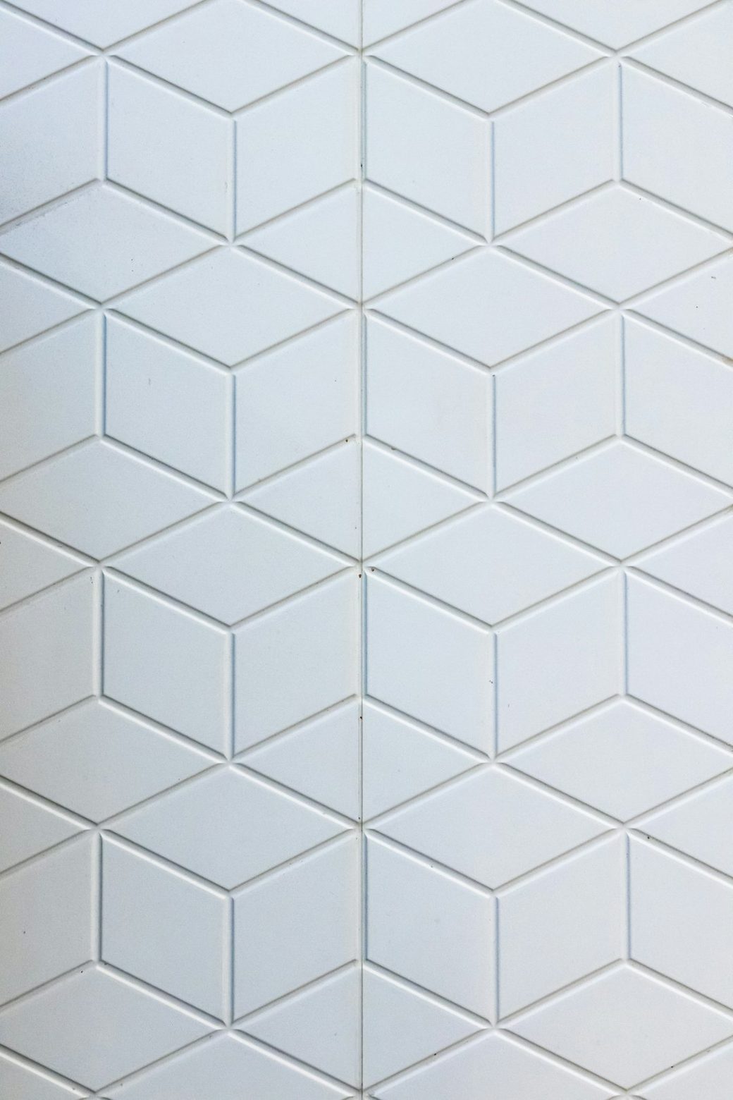 Closeup of white diamond pattern shower tile