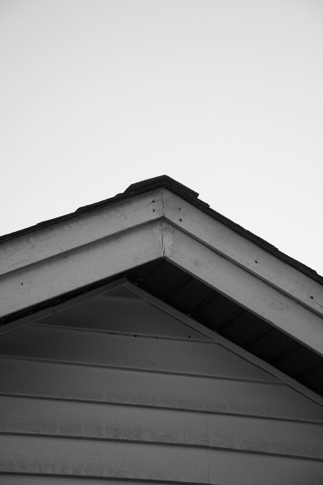 Closeup of weathered gray siding and roofline