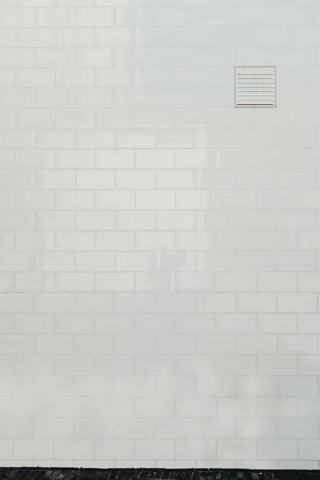 Closeup of plain white shower tile