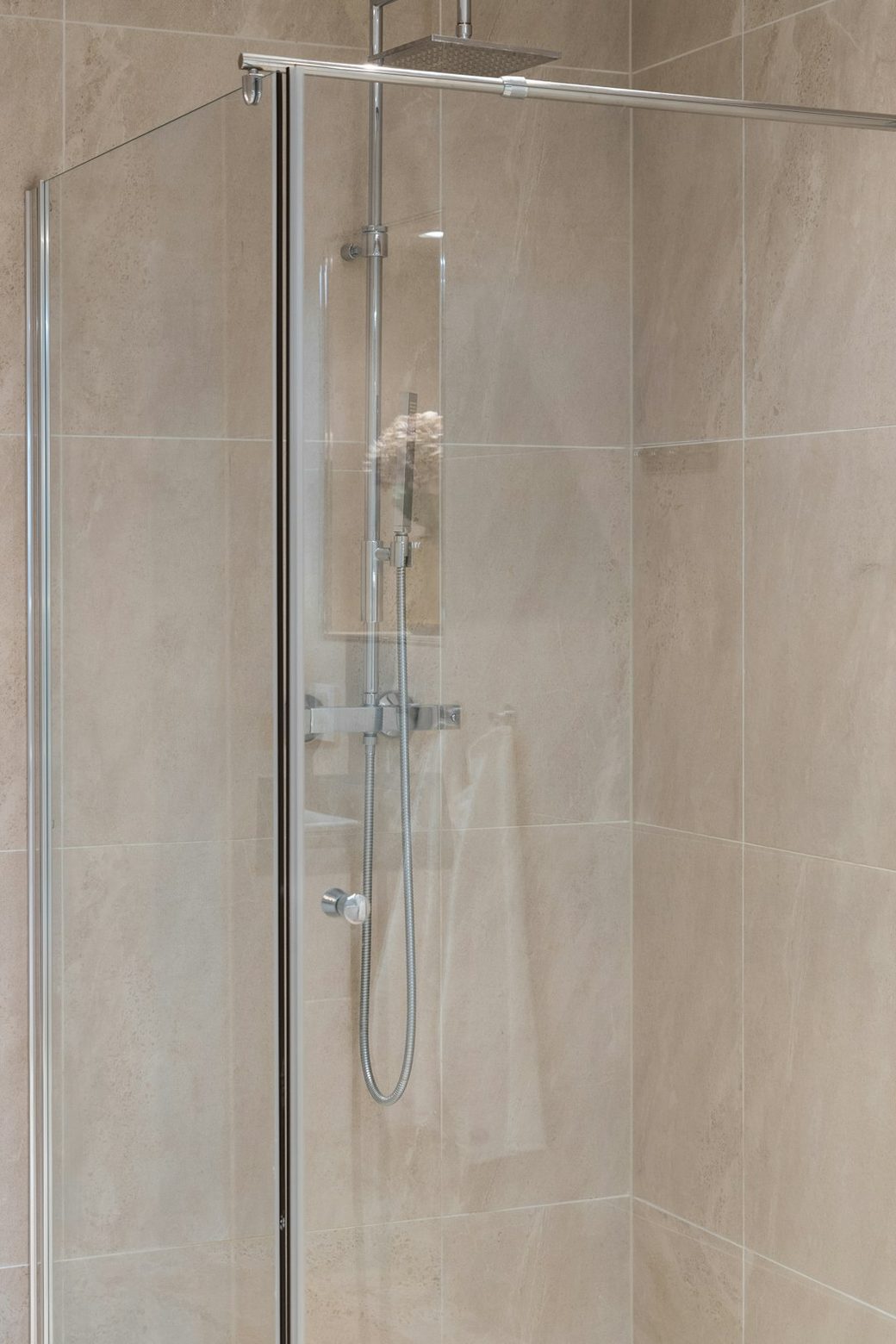 Glass shower enclosure with tile