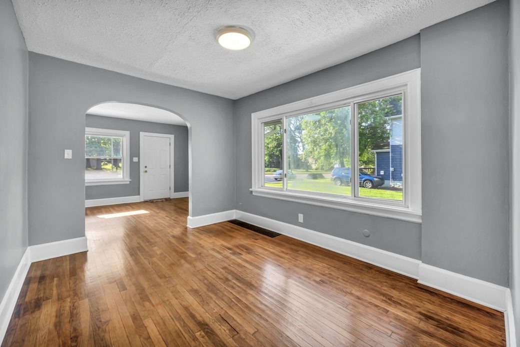 Wood floor room with arched doorway