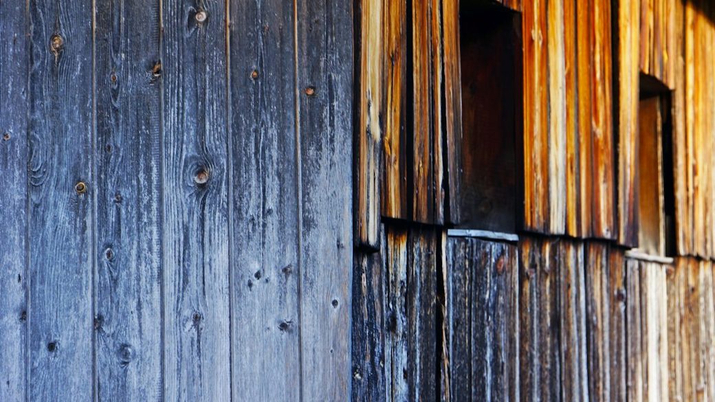 Closeup of dark weathered wood siding