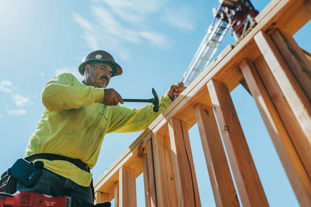 Construction worker framing a wall