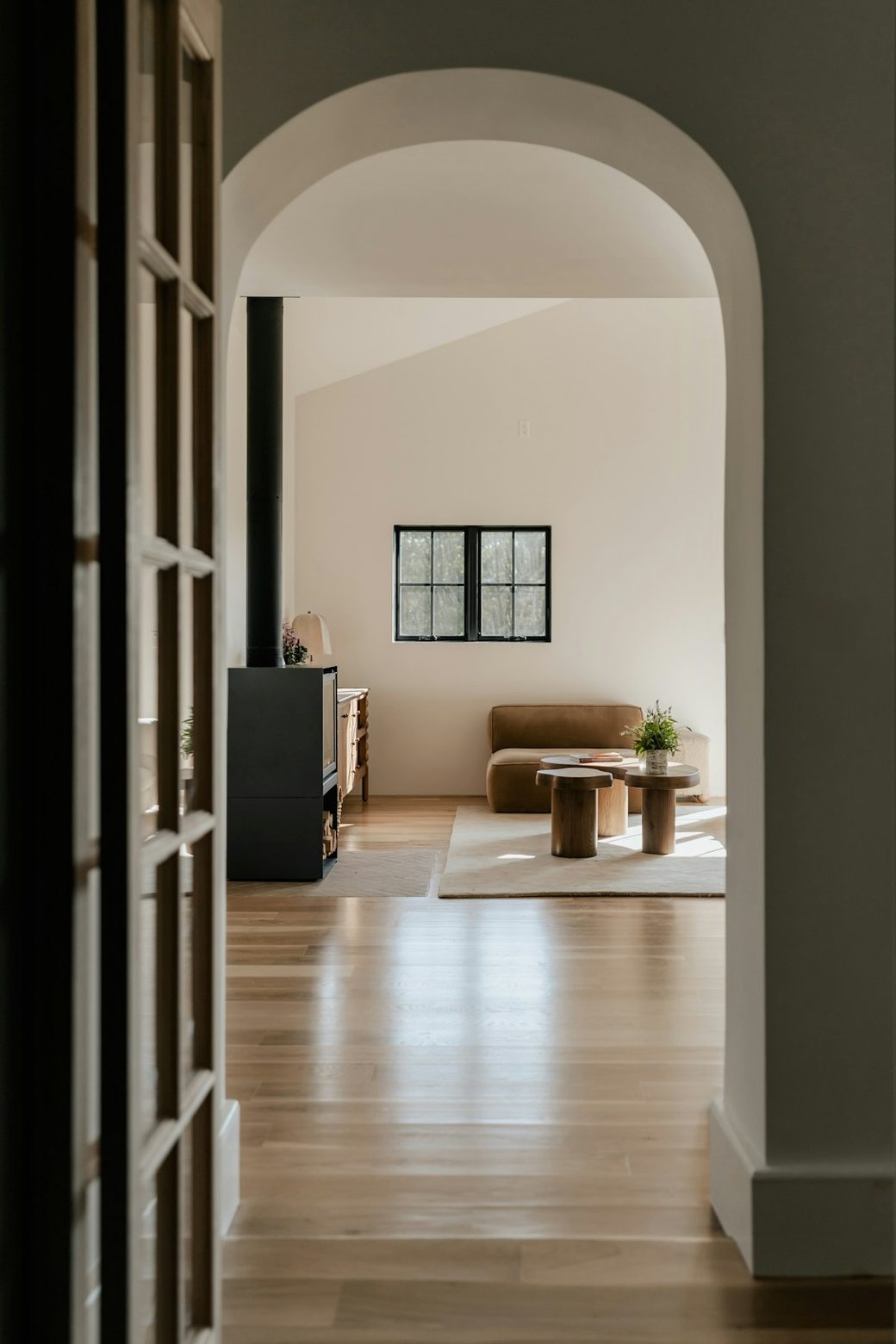Wood floor hallway with arched doorway