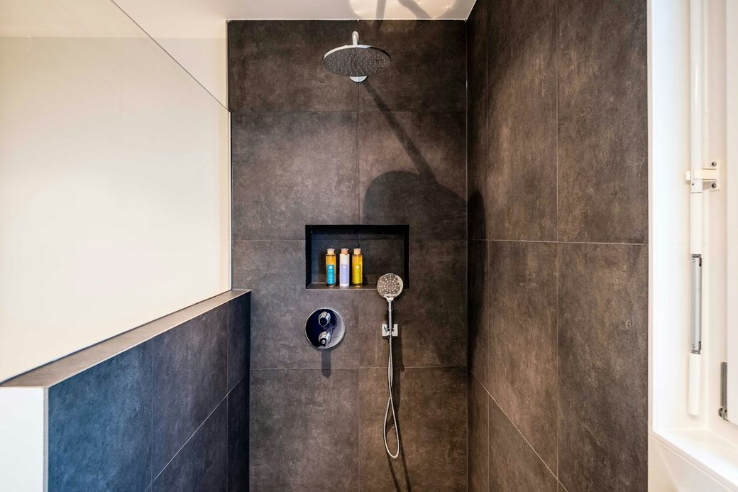 Walk-in shower with dark tile