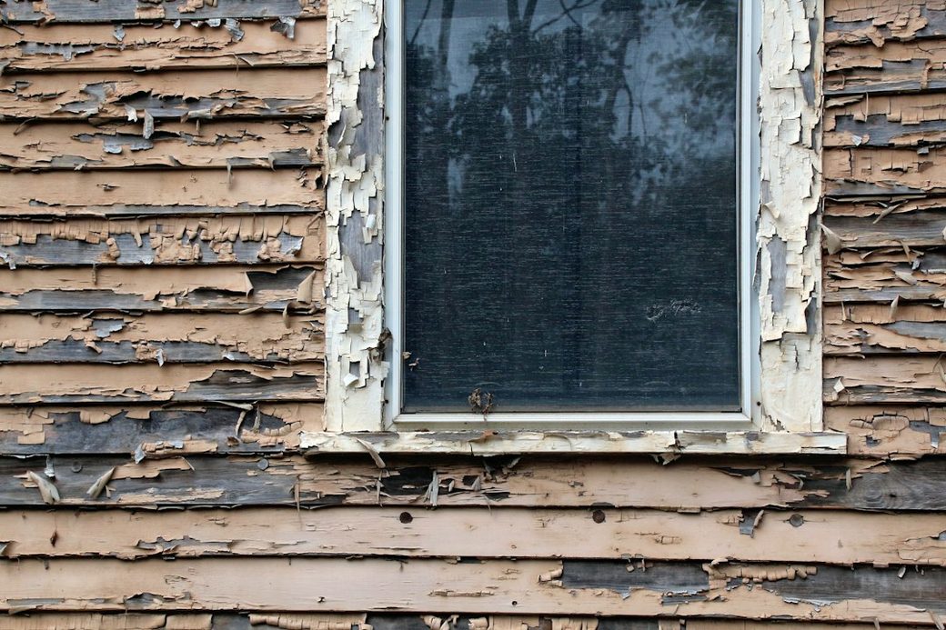 Weathered window frame with peeling paint