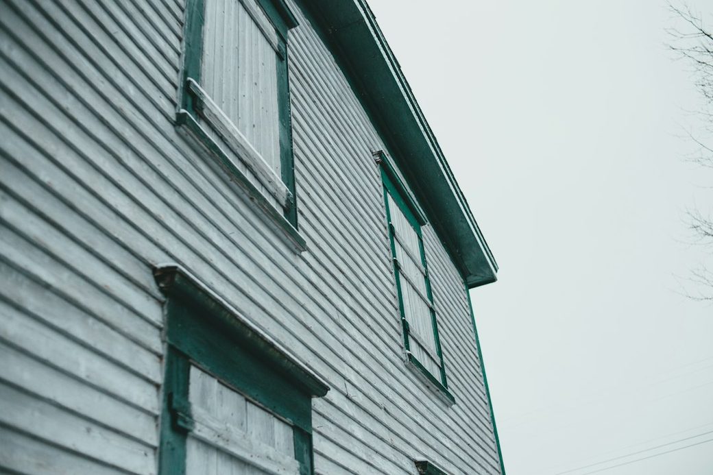 Weathered wood siding corner on an older house