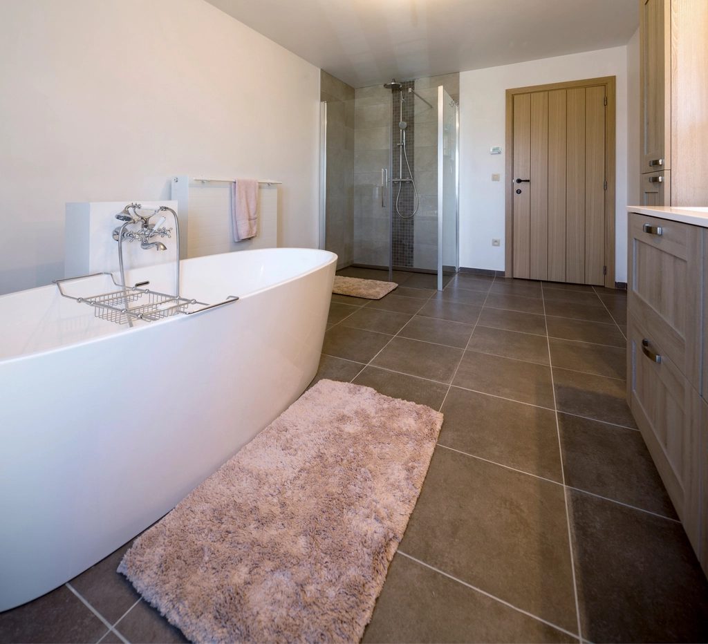 Bright bathroom with a freestanding tub and tile floor