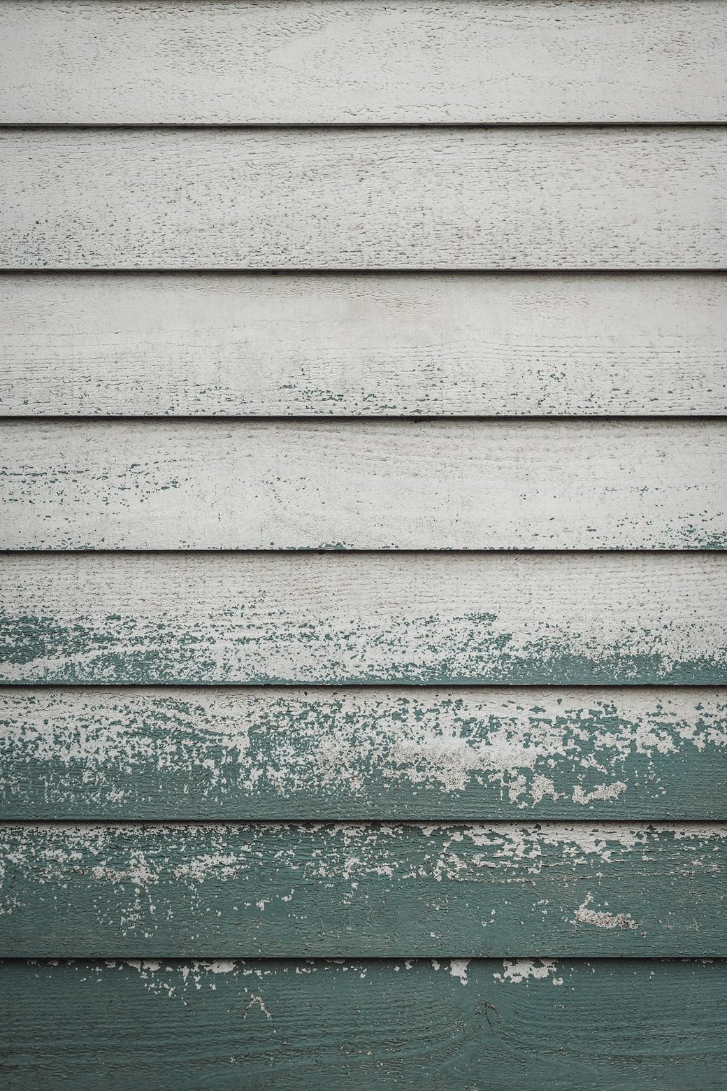 Closeup of weathered and peeling exterior siding